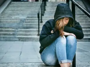 Girl with sweatshirt sitting on steps