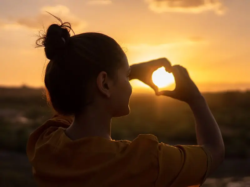 Girl making heart with hands