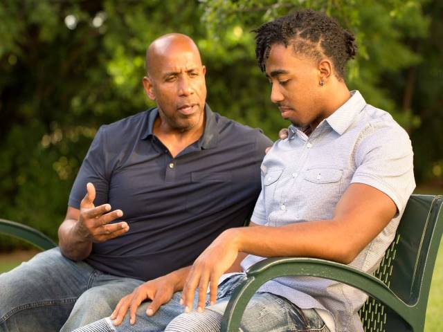 Man consoles a teen in distress.