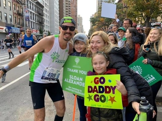 Sloan Alexander at the NYRR Marathon being cheered on by his family.