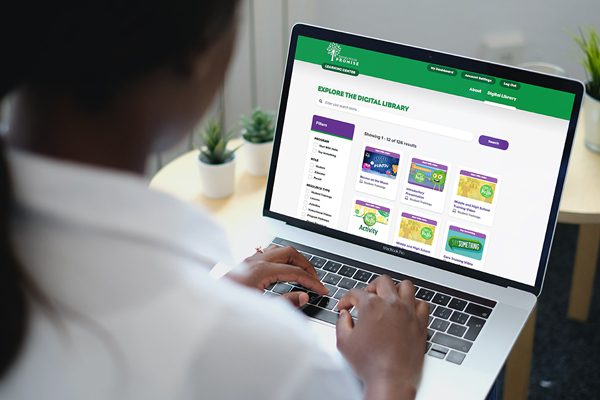 A woman working on her laptop with the the Sandy Hook Promise Digital Learning Center onscreen