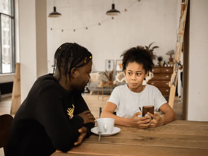 Girl talking to trusted adult at the table