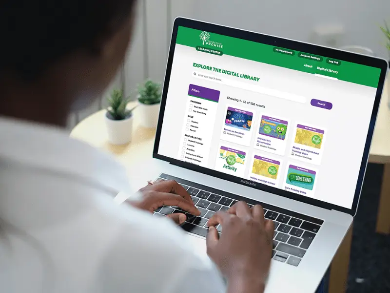 Educator using computer to access the learning center portal.