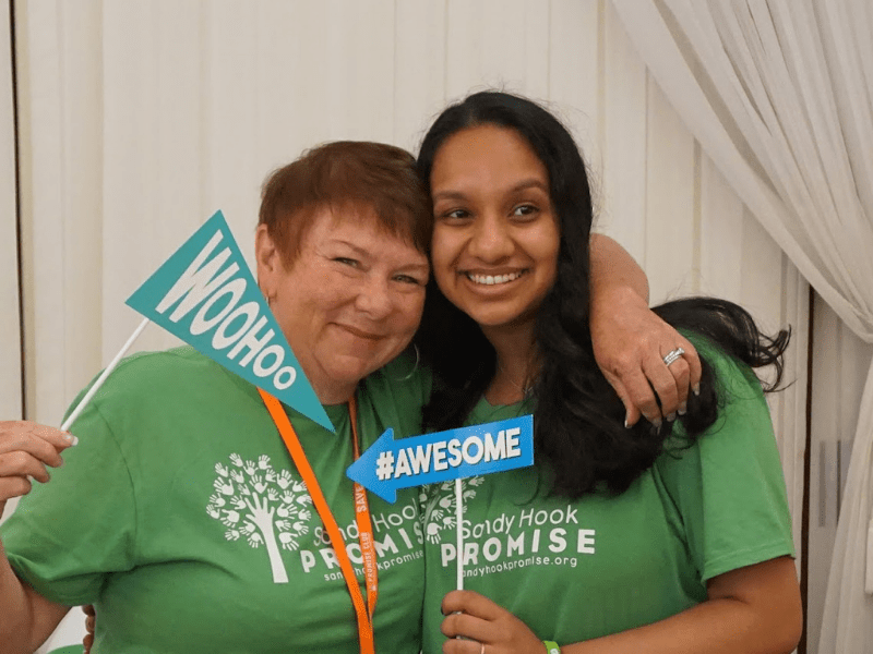 Yabber Dyuthi and advisor Patty posing with Woohoo and #Awesome signs at the Winter institute