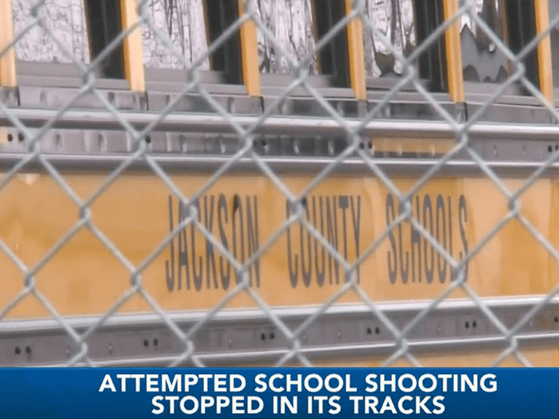 Image of Jackson County School bus on the news. "attempted school shooting stopped in its tracks" on screen.
