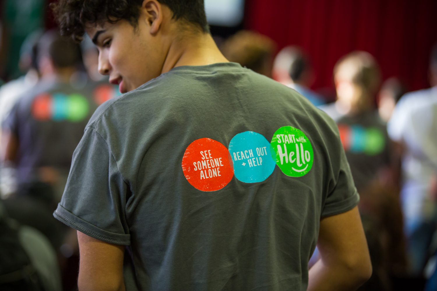 A student showcasing the back of his Sandy Hook Promise t-shirt.