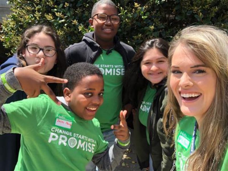 Group of people wearing Change Starts With a Promise shirts