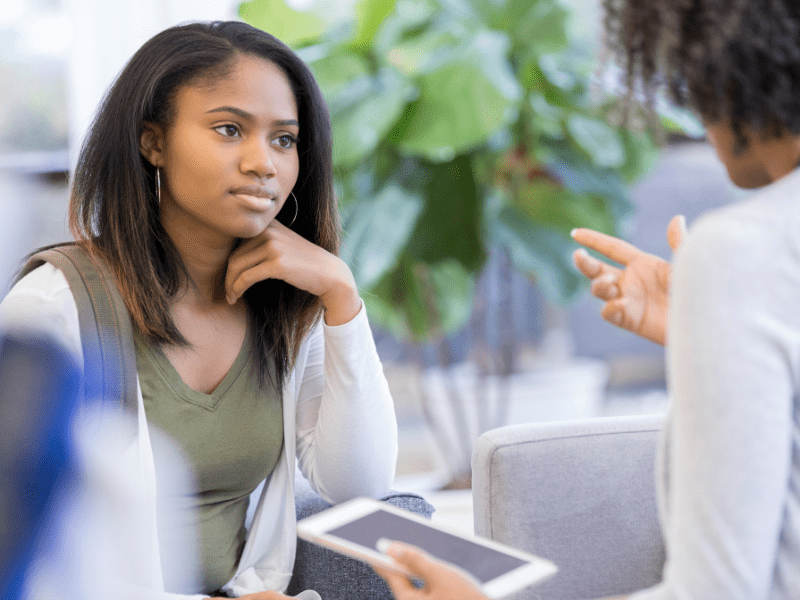 A teenager and a woman having a conversation.