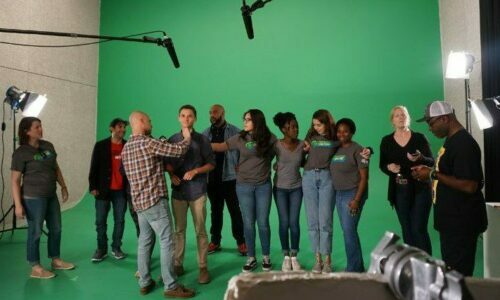 Group of students filming a video, behind the scenes.