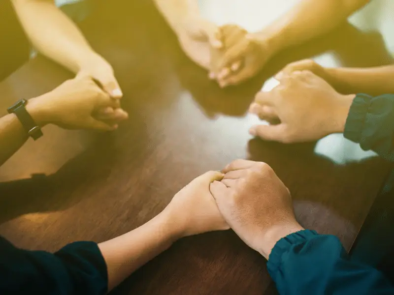 Holding hands in prayer