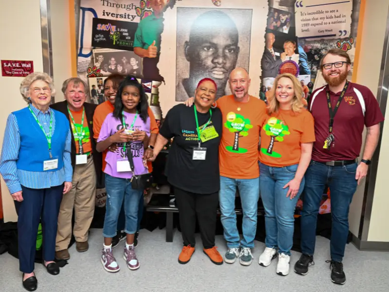 Group picture of Alex Orange's mural