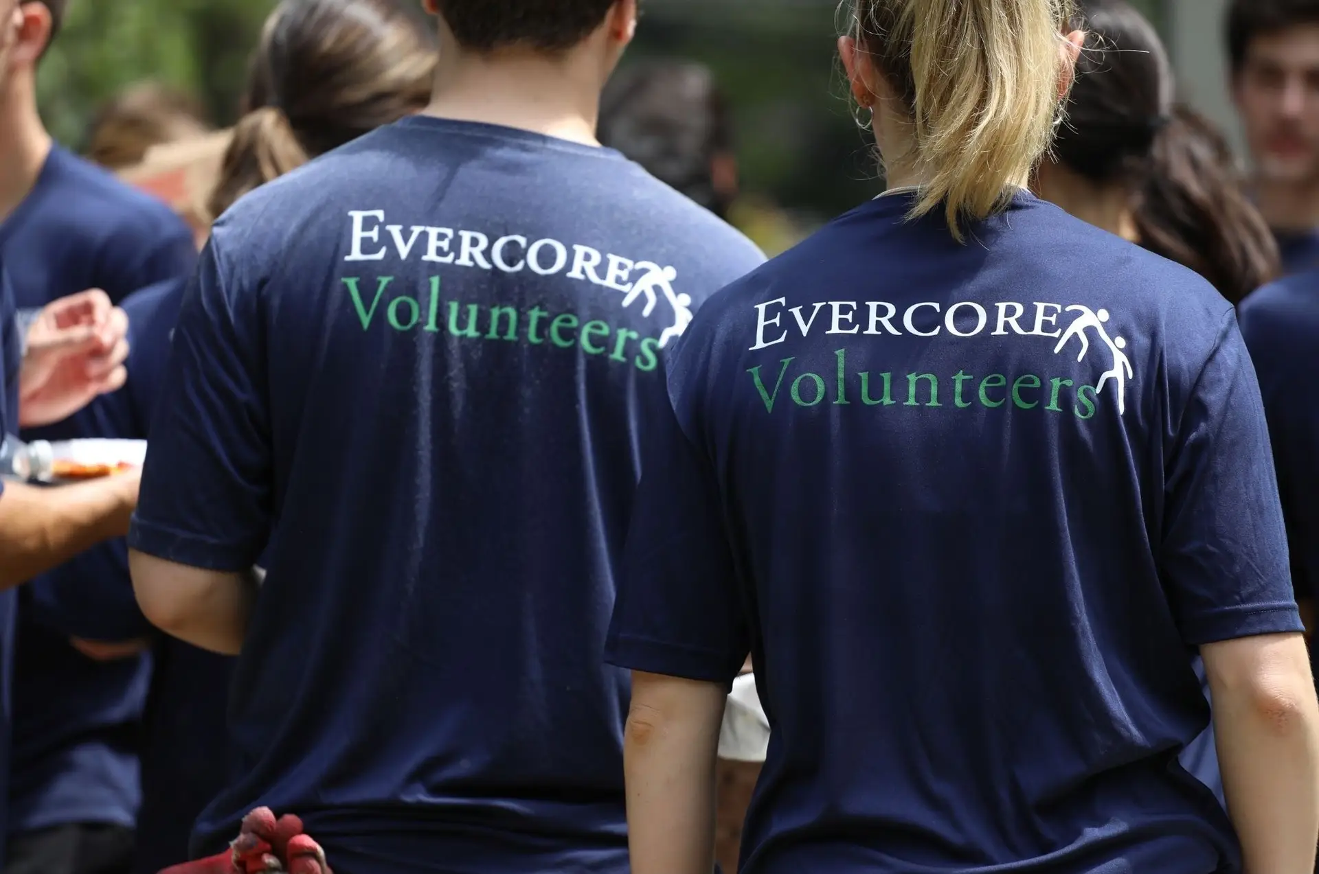 People wearing shirts that say 'Evercore Volunteers'