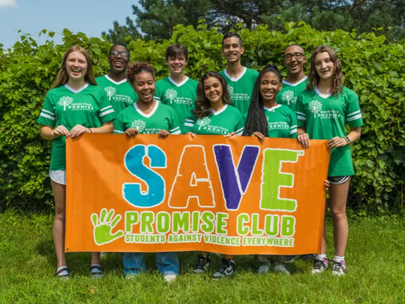 National Youth Advisory Board Members holding SAVE Promise Club banner