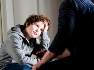 Candid Picture of a Boy Talking To Trusted Adult