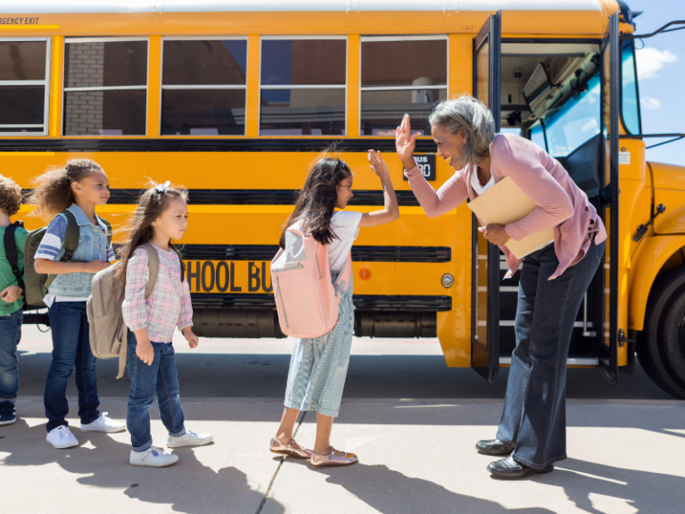 Child gives school bus driver a high-five